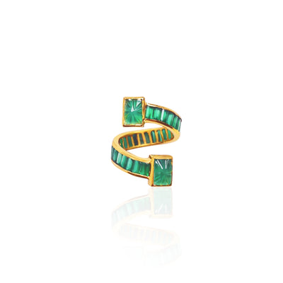Emerald wrap around ring designed with faceted Emeralds on the band and hand carved Emeralds at the top and bottom of the ring.